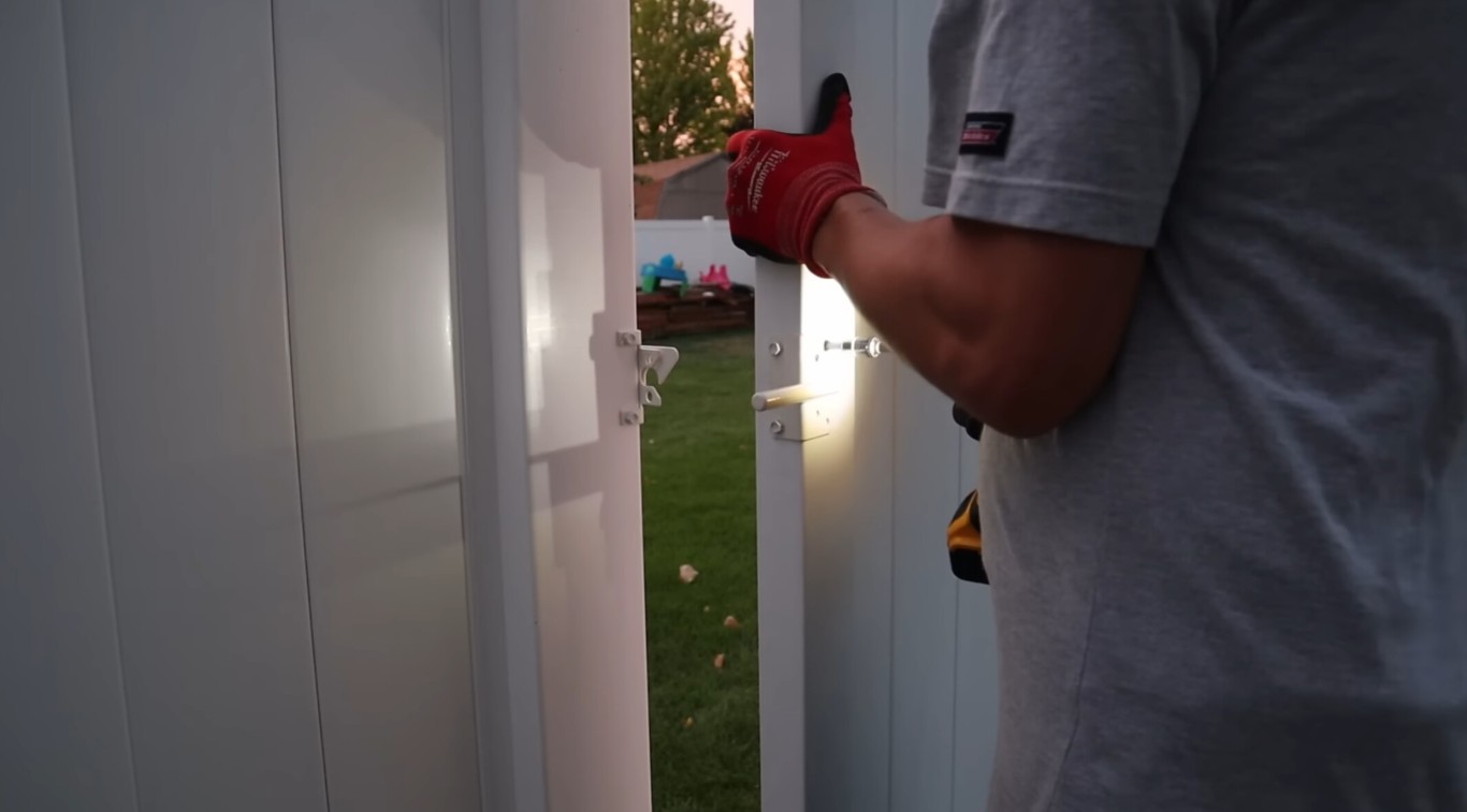 Professional fence contractor installing white vinyl fence in Germantown, MD